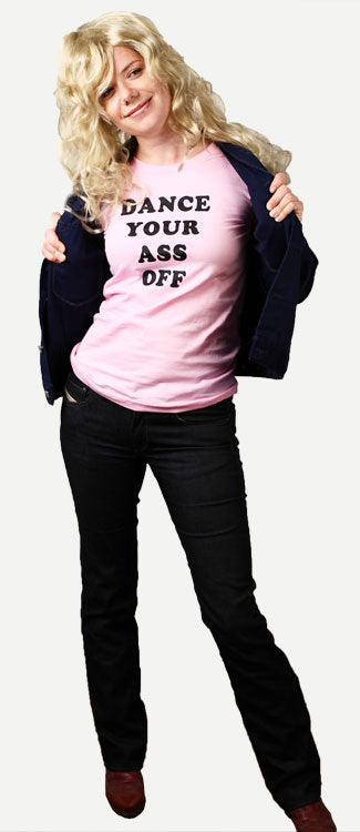 Costume guide for Ariel Moore from the movie Footloose. Ariel wears a pink t-shirt that says "Dance Your Ass Off" in black lettering, She has long blonde hair and wears a black jacket and black pants.