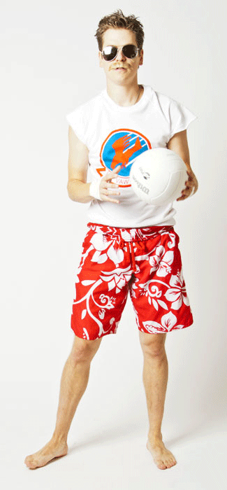 Costume Guide for Goose from the movie Top Gun.  Goose wears a white sweatshirt with the arms cut off, aviator sunglasses, and red floral swimming trunks.  He holds a volleyball and has short hair and a mustache.