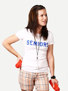 Costume guide for Darla Marks from the movie Dazed and Confused.  Darla has long brown hair and holds a red ketchup dispenser in each hand. She wears a white t-shirt with blue lettering that says Seniors, and wears plaid shorts and a whistle around her neck.