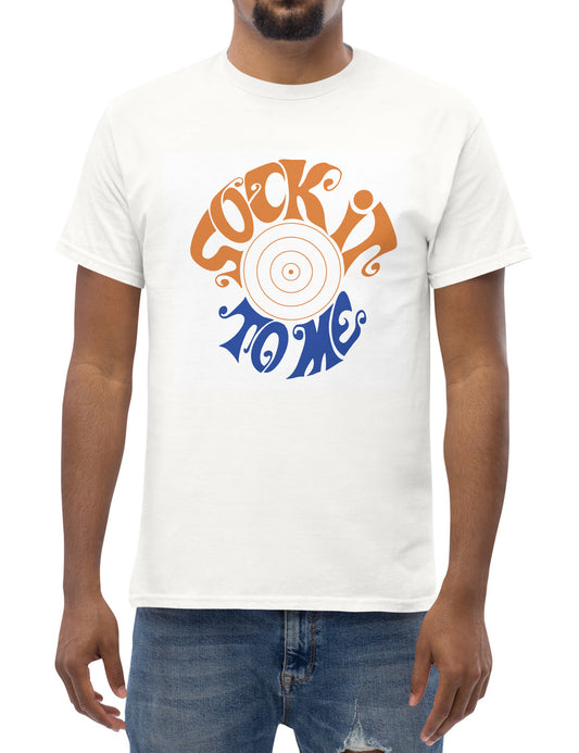 Person wearing a white t-shirt with a graphic design and text.  Text says "Sock It To Me" in orange and blue font.