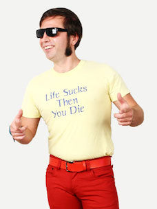 Costume guide for Stiles from the movie Teen Wolf.  Stiles has dark hair and long sideburns.  He wears black sunglasses, red pants, a red belt, and a yellow t-shirt that says "Life Sucks Then You Die" in blue lettering.