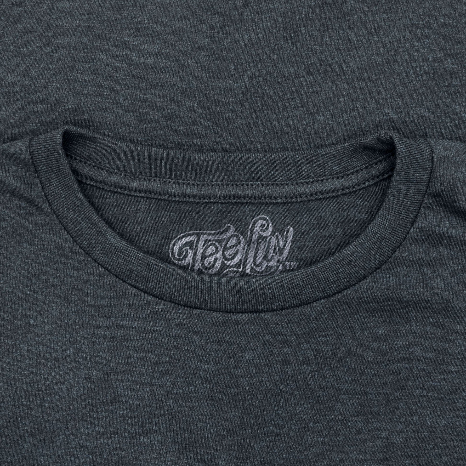 Close-up of a dark gray t-shirt with 'Tee Luv' logo on the neckline.