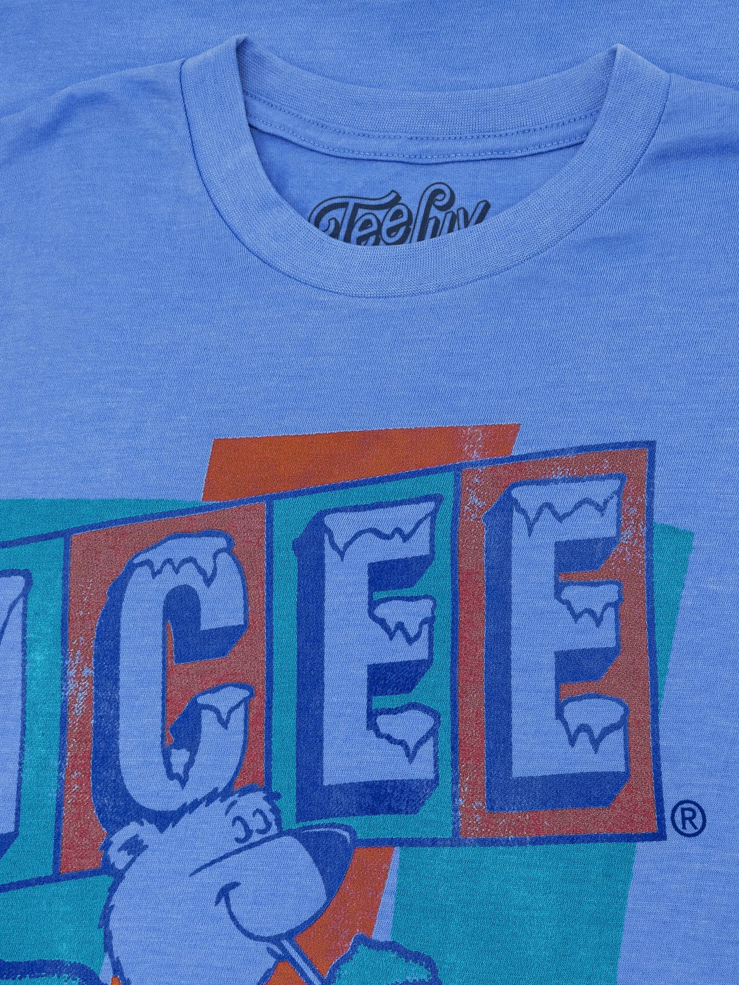 Blue t-shirt with a logo featuring the word 'ICEE' and a bear graphic on a blue background.