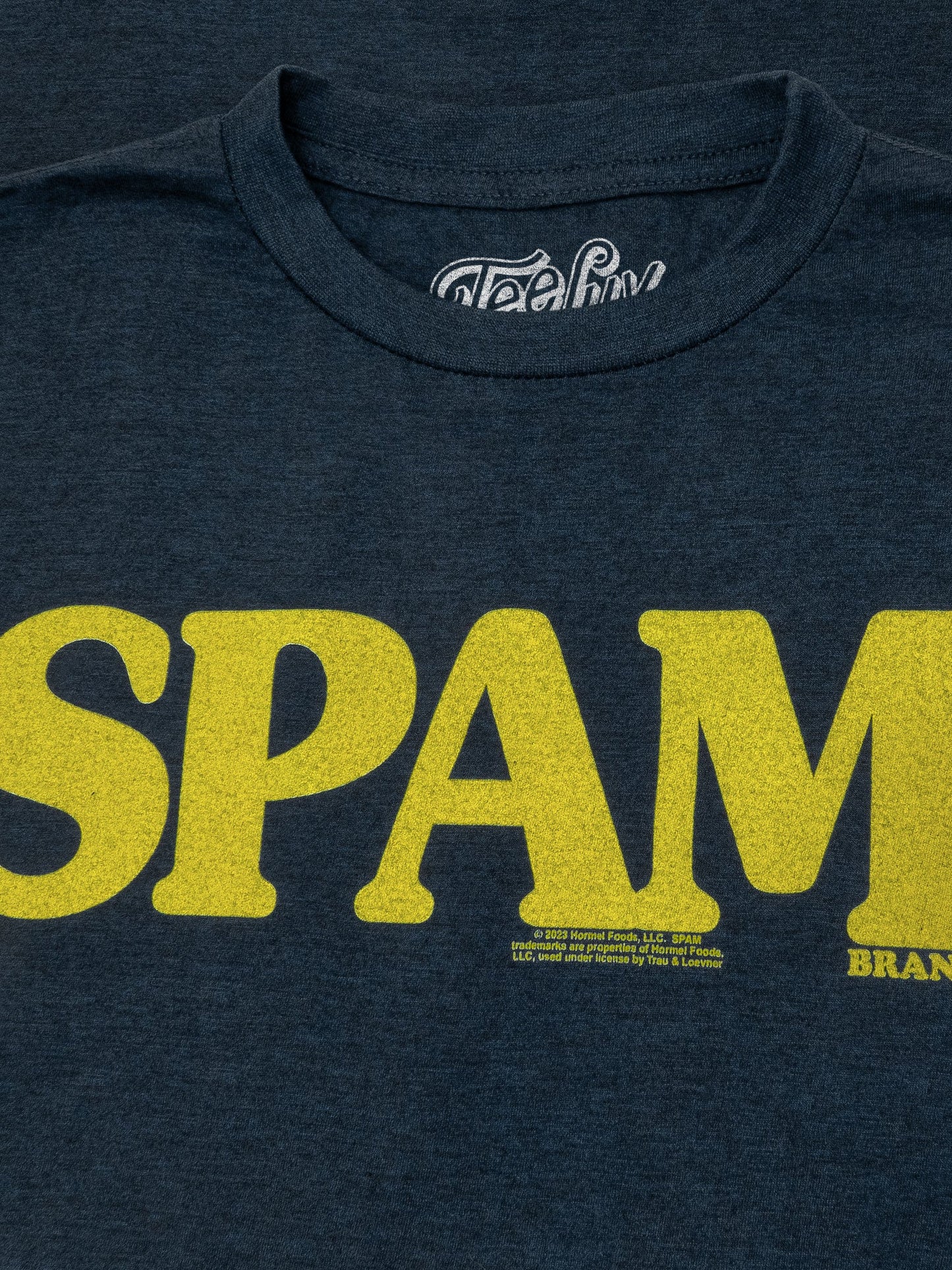 Navy blue t-shirt with yellow 'SPAM' branding on a dark background