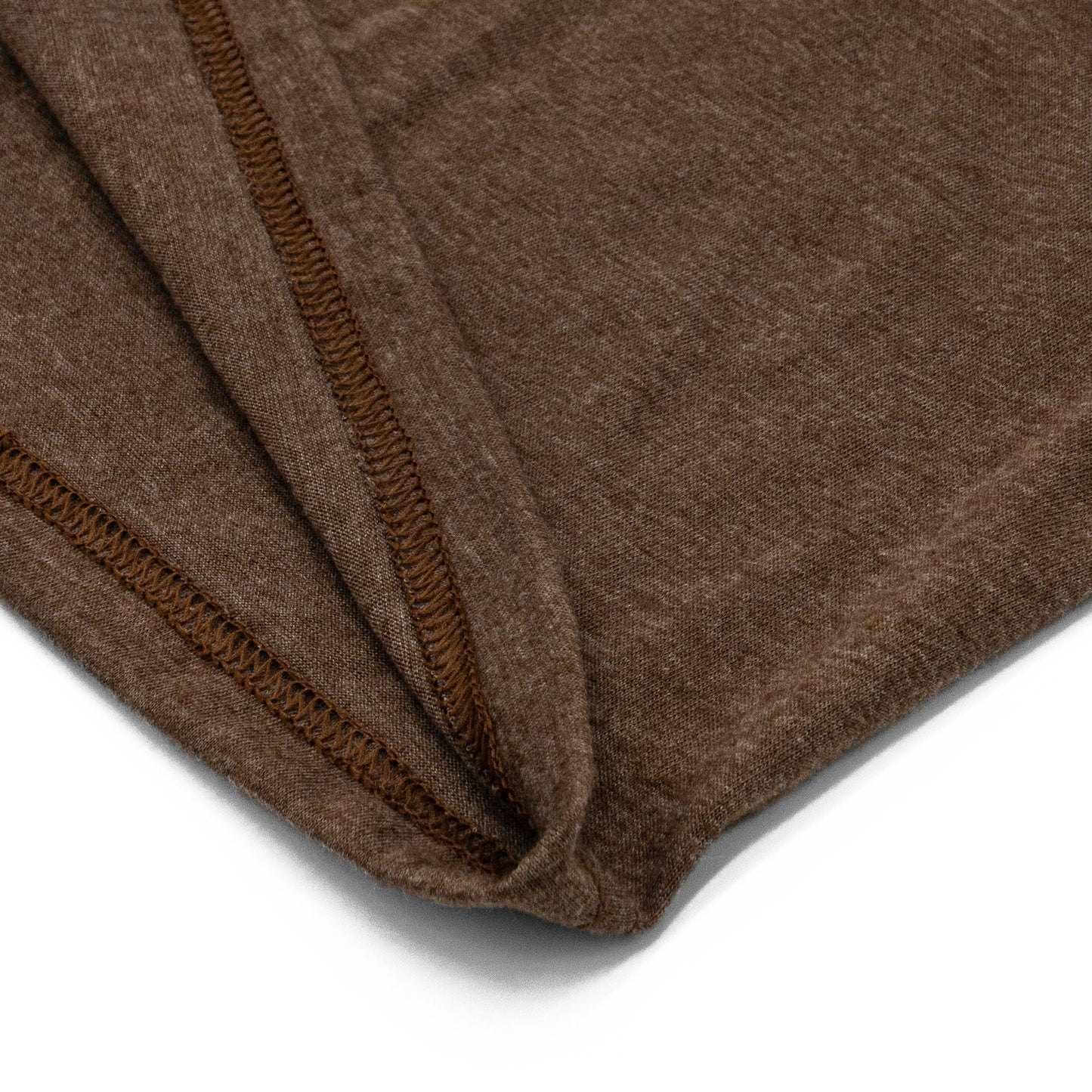 Close-up of a brown fabric with a visible seam on a white background