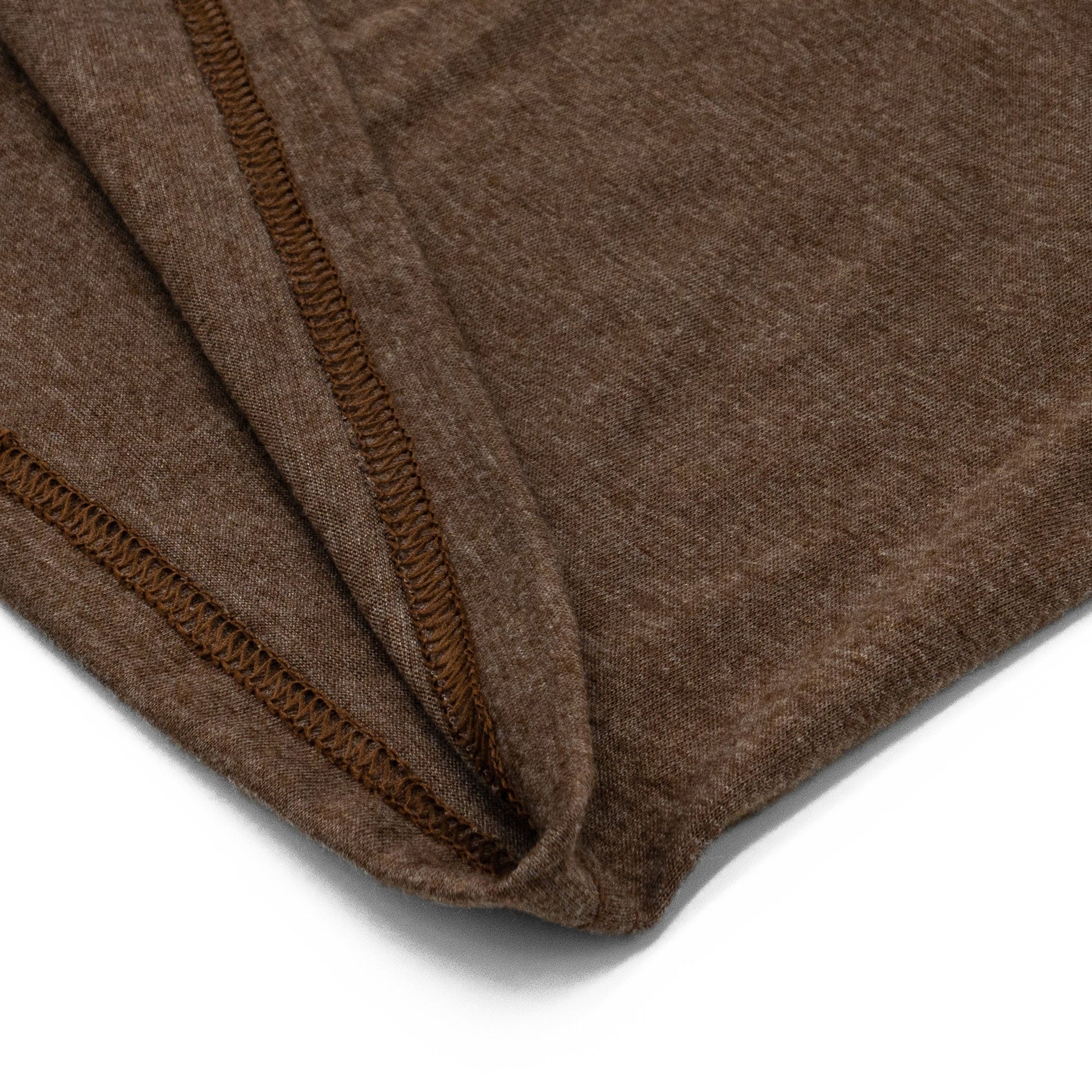 Close-up of a brown fabric with a visible seam on a white background