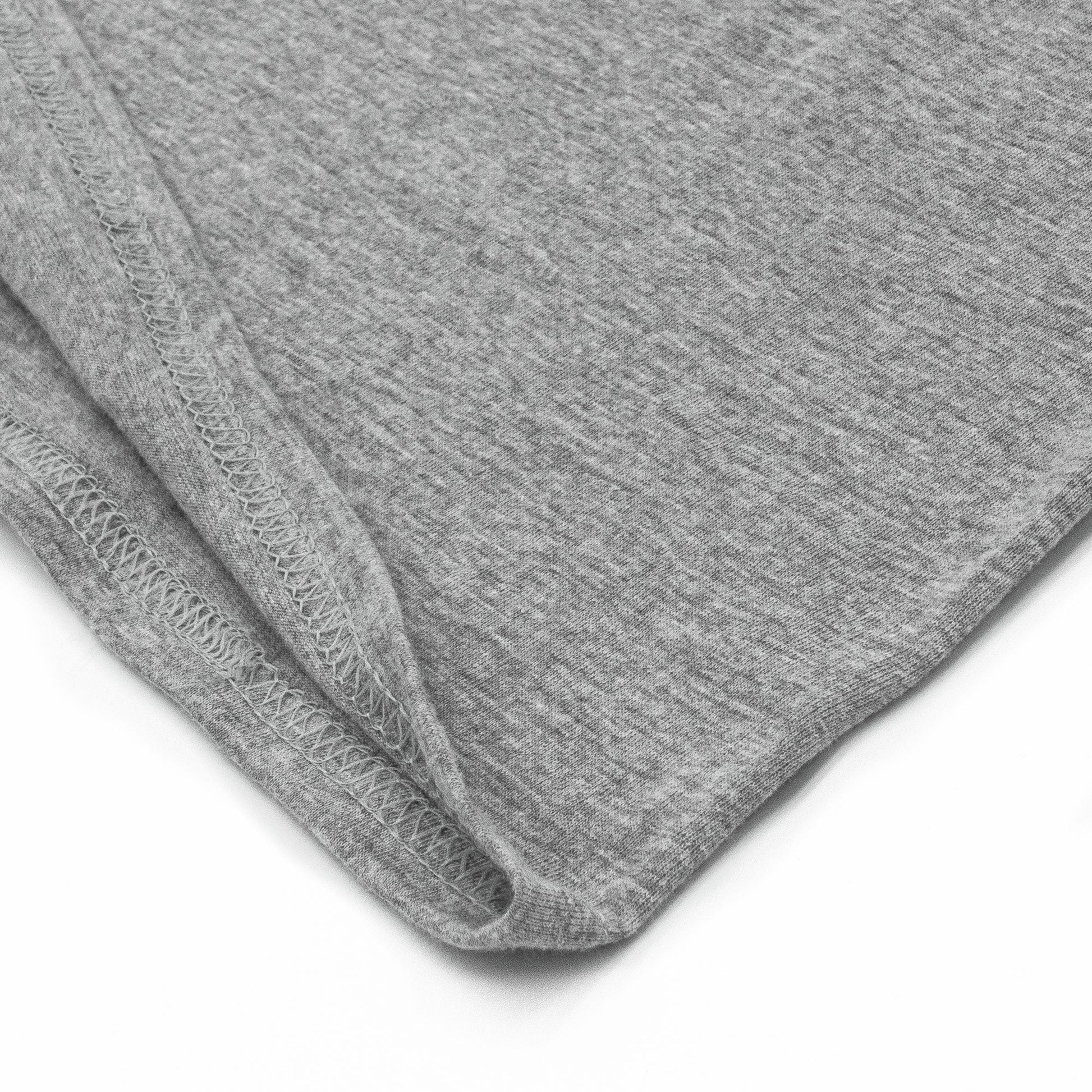 Close-up of gray fabric with a visible seam on a white background