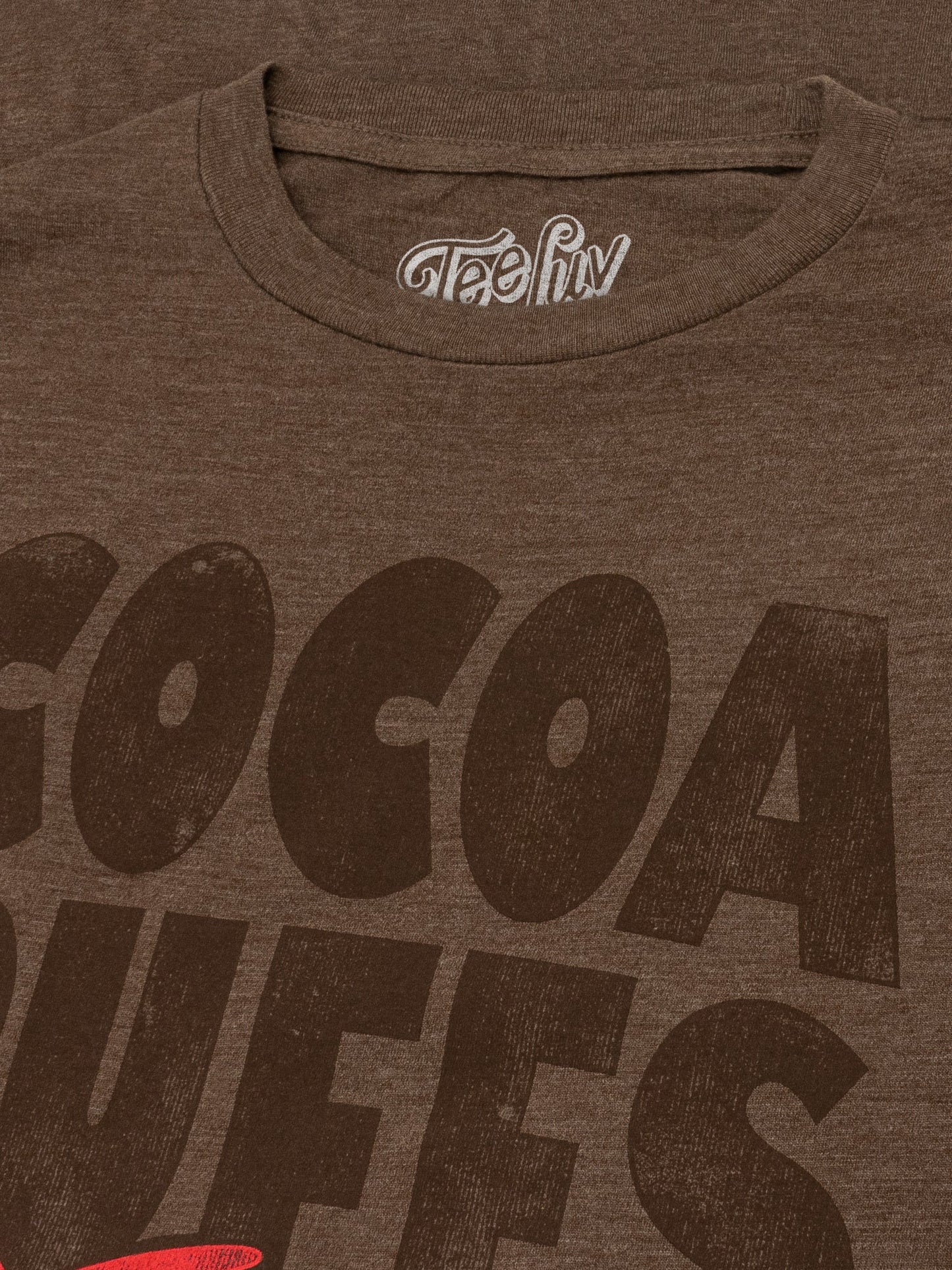 Brown t-shirt with 'Cocoa Dweels' text and a visible brand logo on a brown background