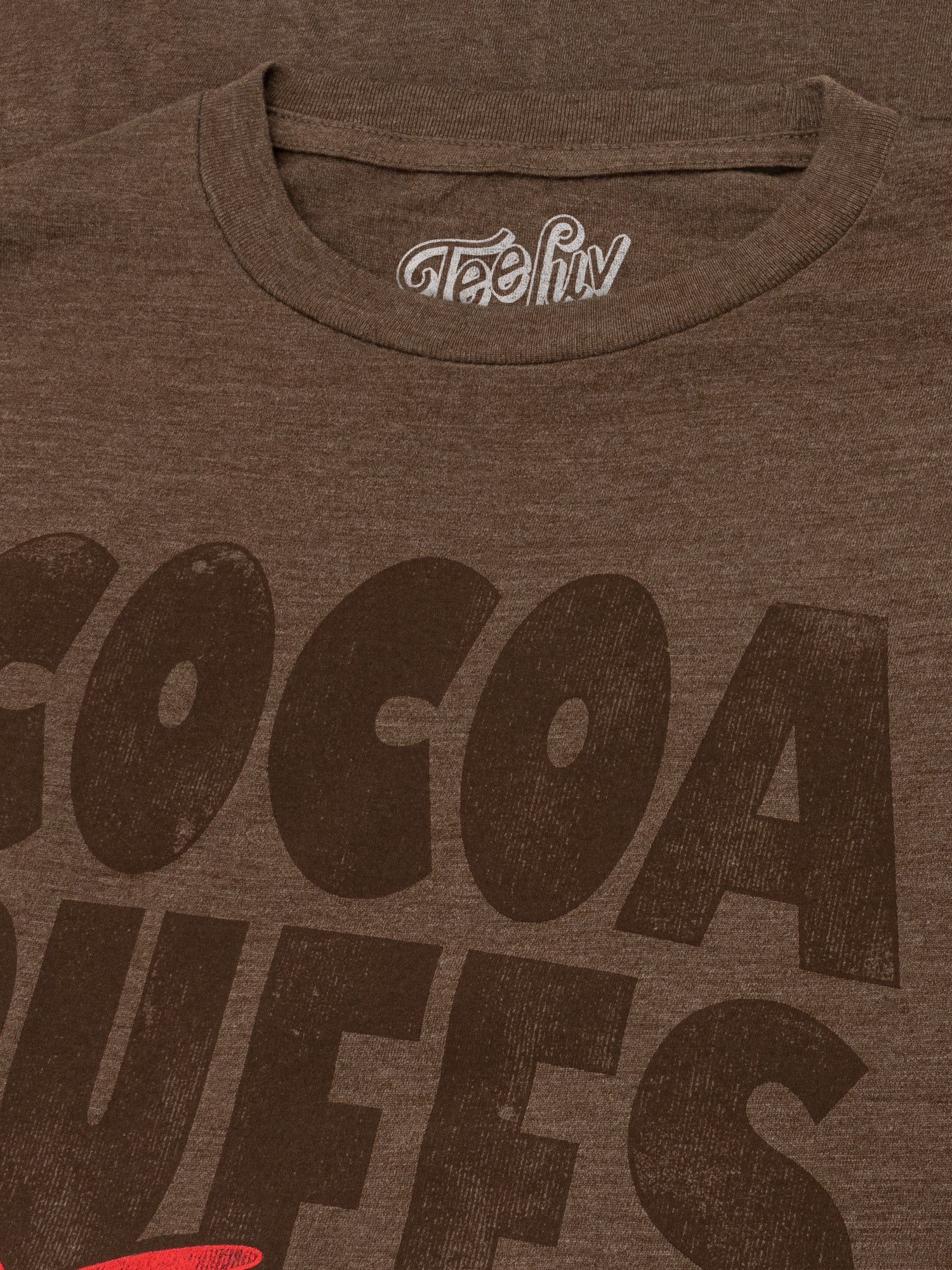 Brown t-shirt with 'Cocoa Dweels' text and a visible brand logo on a brown background