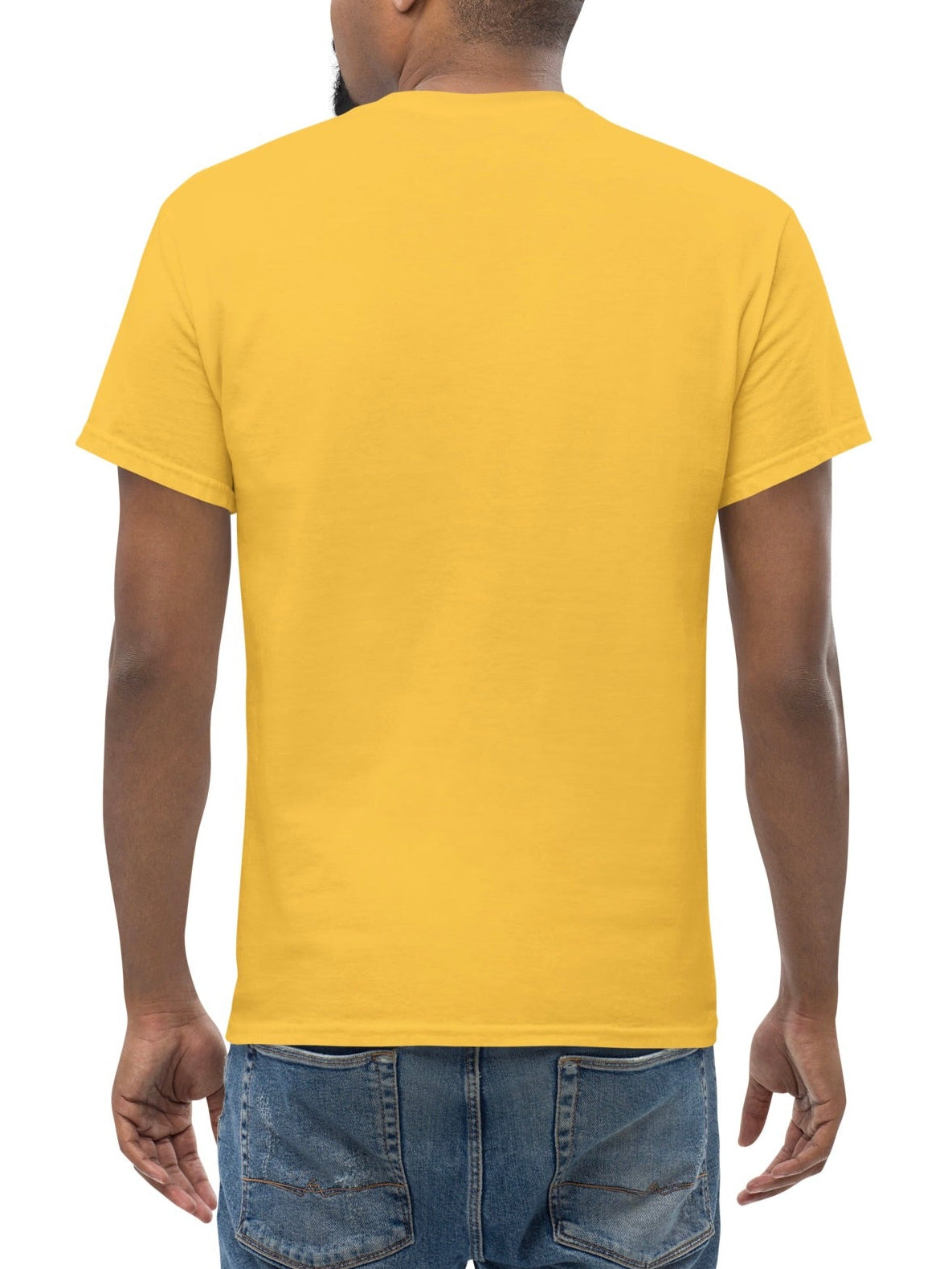 Man wearing a yellow t-shirt and blue jeans on a white background