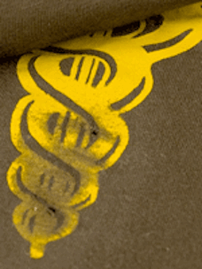 An olive green and yellow t-shirt that has been distressed using sandpaper