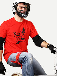 Costume guide for Cru Jones from the movie Rad.  Cru wears a red t-shirt that says Rad Racing, jeans with a red bandanna tied around the leg, a white helmet, black gloves, and is riding a bike.