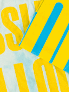 A blue and yellow shirt that has been faded using bleach.