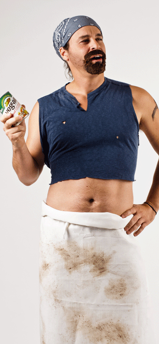Costume Guide for Gene from the movie Wet Hot American Summer.  Gene wears a cropped blue t-shirt, a dirty apron tied around his waist, and a blue bandanna tied around his head.  He has a goatee and holds a can of mixed vegetables.