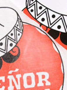 A red, black and white shirt that has been faded using acetone. 
