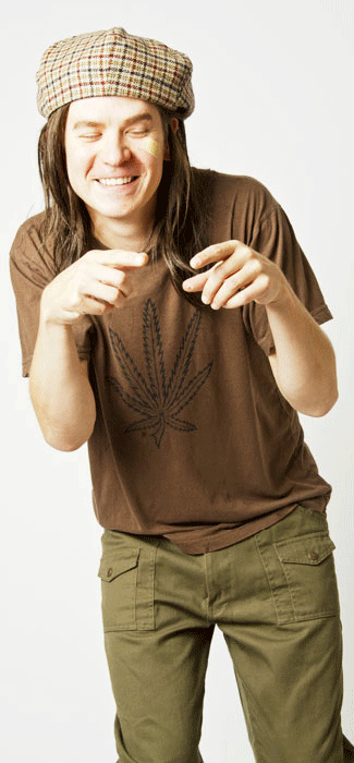Costume guide for Slater from the movie Dazed and Confused.  Slater wears a plaid scally cap backwards, a brown shirt with a black pot leaf printed on it, and olive green pants.  He has long brown hair.