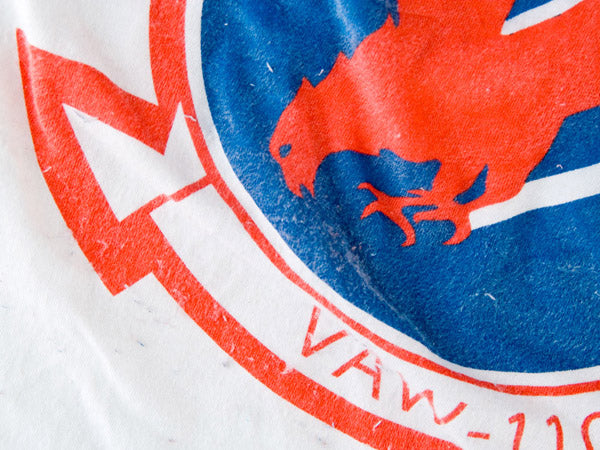 A red, blue and white shirt that has been aged using salt and washing.