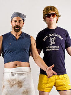 Costume guide for camp cook and camp counselor from the movie Wet Hot American Summer.  Gene wears a blue cropped shirt and a dirty apron.  Gary wears a dark blue shirt and yellow shorts.